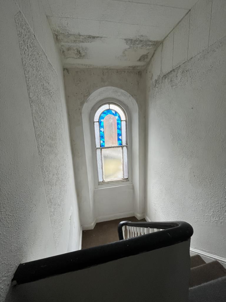 Lot: 30 - MIXED USE INVESTMENT IN TOWN CENTRE - View from landing in flat including the stairway, photograph provided to the auctioneers
